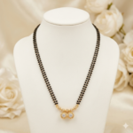 Two line black bead mangalsutra with gold-tone twin round stone pendant