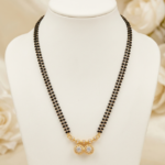 Two line black bead mangalsutra with gold-tone twin round stone pendant