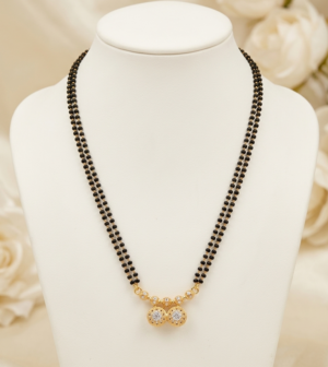 Two Line Black Bead Mangalsutra with Twin Round Pendant Two line black bead mangalsutra with gold-tone twin round stone pendant
