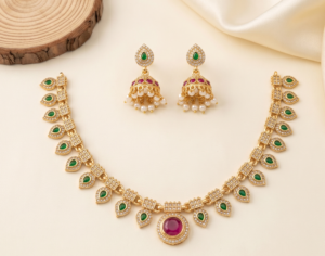 Green leaf stone necklace set with red centre pendant and pearl-drop jhumka earrings