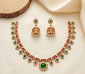 Green leaf necklace set with pink stones, green pendant and pearl-drop jhumka earrings