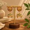 Elephant Motif Matte Gold Jhumka Earrings with Ruby and Green Stones